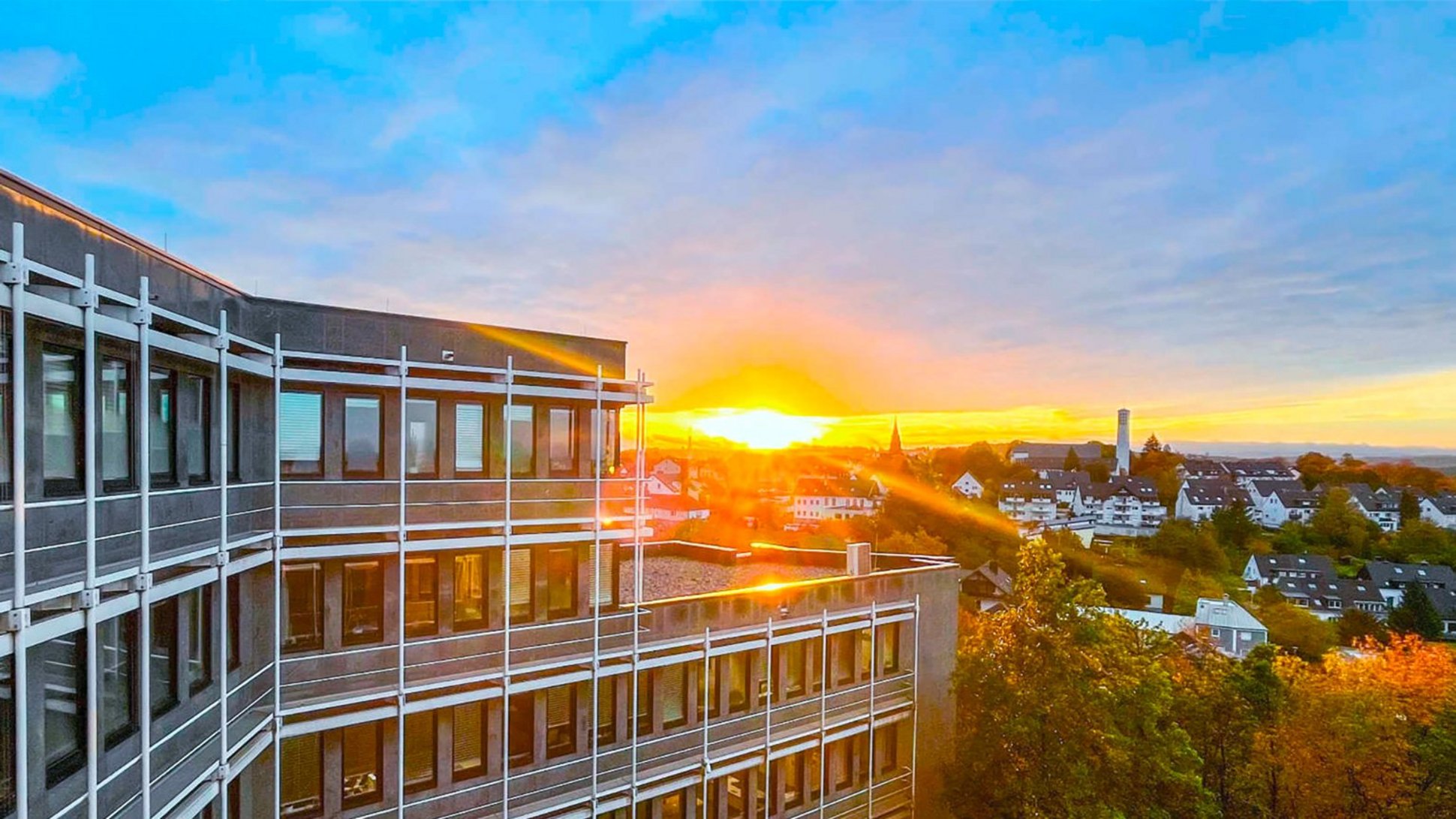 Das Kreishaus Lüdenscheid des Märkischen Kreises bei Sonnenaufgang und leicht bewölkten Himmel.